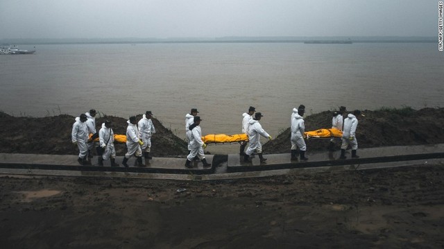 Rescue personnel carry the bodies of victims away from the riverbanks of the Yangtze River in Jianli County, China, on Wednesday, June 3. The Eastern Star cruise ship sank late Monday, June 1, in stormy weather, with more than 450 passengers and crew on board.