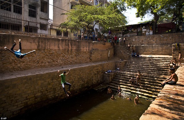 Many have not even attempted to go outside amid searing temperatures. But these men cooled off by plunging into a water tank in New Delhi