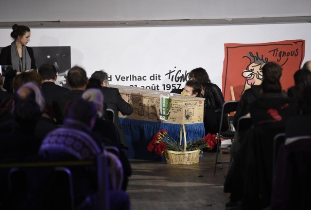 People write on the coffin of Bernard (Tignous) Verlhac.