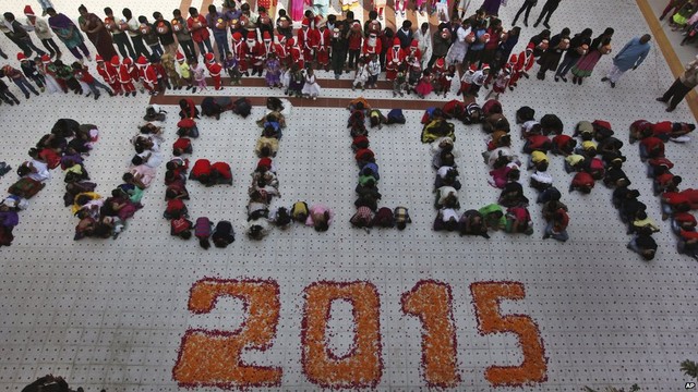 Indian students form numbers representing the year 2015 during a function to welcome the New Year at a school in Ahmadabad, India, on 31 December 2014