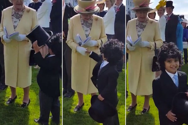 Boy takes off his top hat and shakes the Queens hand