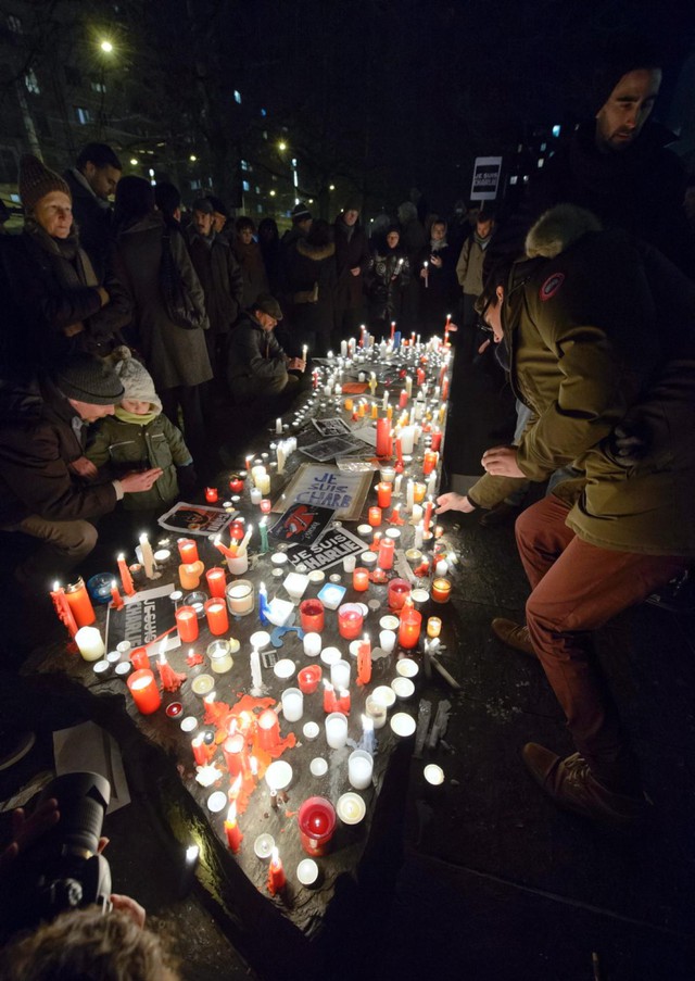 People gather for a rally in Geneva, Switzerland, in solidarity with the journalists murdered and injured yesterday at the offices of Charlie Hebdo magazine. Masked gunmen with automatic rifles killed 12 people at the Paris headquarters of the weekly.