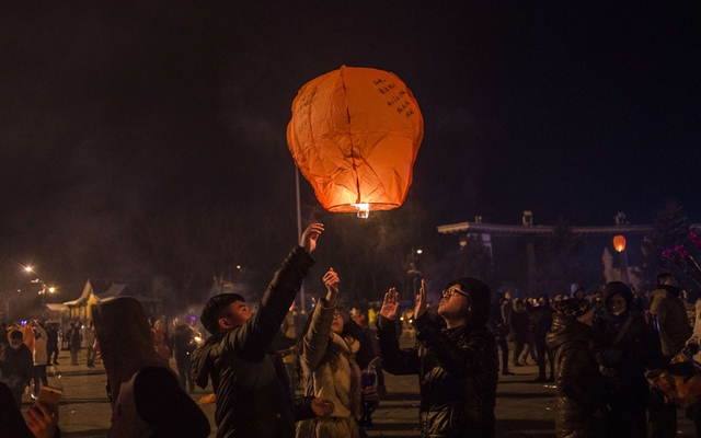People release a sky lantern to celebrate the New Year in Harbin, China