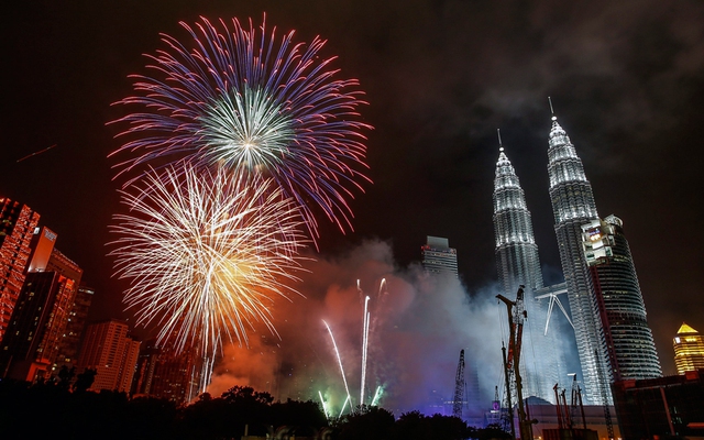 Fireworks explode near Malaysias landmark Petronas Towers during the New Year celebrations in Kuala Lumpur