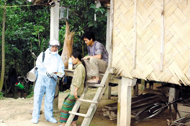 Cán bộ y tế huyện Văn Chấn (Yên Bái) phun hóa chất diệt muỗi, hướng dẫn người dân phòng tránh bệnh sốt rét.
Ảnh: Dương Ngọc