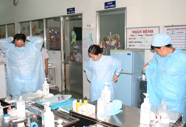 Đội tiếp nhận bệnh nhi nguy cơ cao nhiễm Mers-Cov tại khoa Cấp cứu BV Nhi Đồng 1 chuẩn bị quần áo phòng hộ và thiết bị y tế hỗ trợ bệnh nhi.