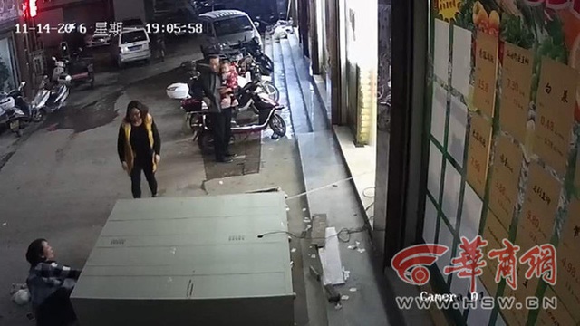 
Người mẹ bị kẹt ch&acirc;n phải, c&ograve;n cậu con trai bị cả chiếc tủ cao gần 2m đ&egrave; l&ecirc;n người.
