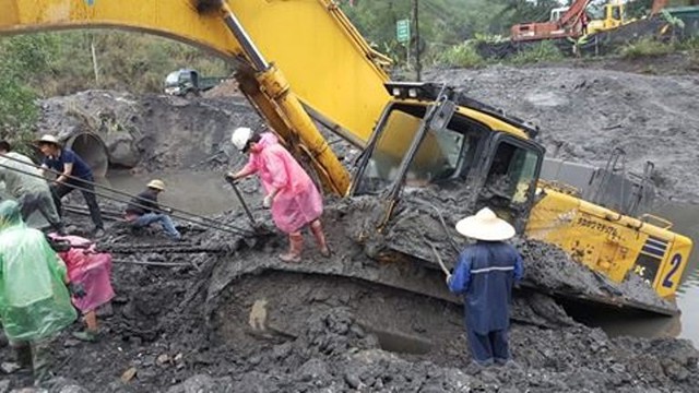 
C&aacute;c đơn vị cứu hộ đang t&iacute;ch cực l&ecirc;n phương &aacute;n đưa m&aacute;y x&uacute;c 85 tấn ra khỏi b&ugrave;n lầy. Ảnh: H.Tuấn
