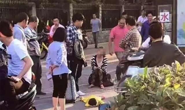 
Trong khi con nằm vật ra đường kh&oacute;c th&igrave; người mẹ ngồi tr&ecirc;n vali v&agrave; kh&ocirc;ng ngừng mắng nhiếc.

