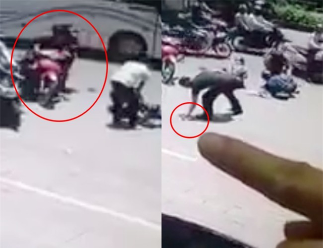 Lợi dụng l&uacute;c mọi người kh&ocirc;ng ch&uacute; &yacute;, người đ&agrave;n &ocirc;ng nhanh ch&oacute;ng nhặt chiếc điện thoại của nạn nh&acirc;n rồi bỏ đi. Ảnh cắt từ clip