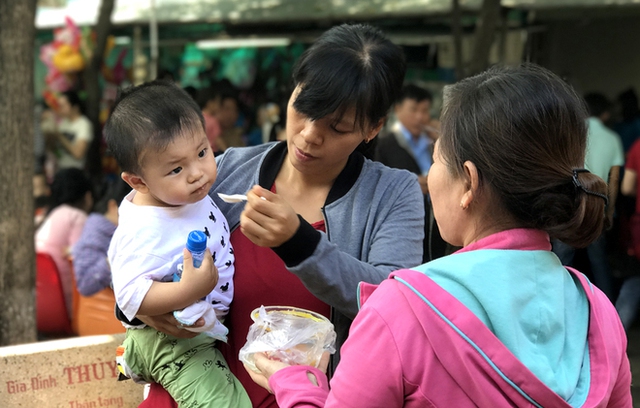 Trong thời gian chờ đến lượt khám, Phát được mẹ cho ăn cháo. Cậu bé ăn khá khỏe và ngoan ngoãn.