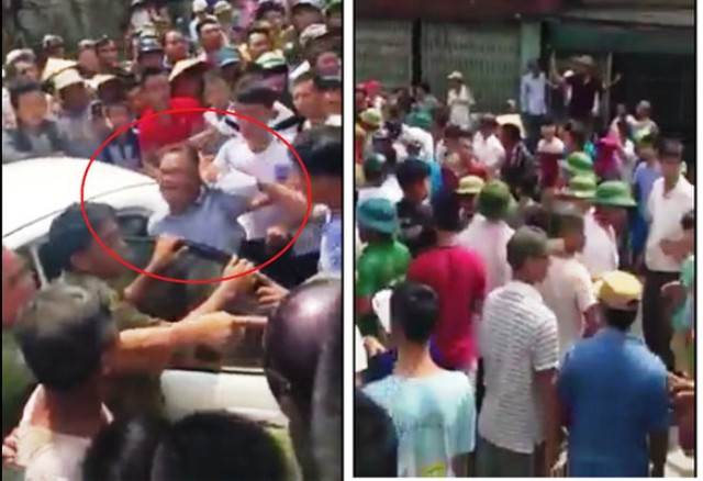 
Hàng trăm người dân bao vây 2 người đàn ông Trung Quốc trước cửa nhà anh Hồi. Ảnh: Cắt từ clip
