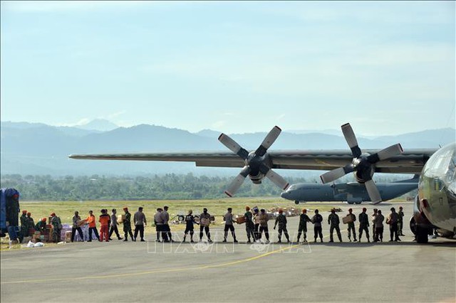 Binh sĩ và cảnh sát Indonesia chuyển hàng cứu trợ từ máy bay ở Palu, tỉnh Trung Sulawesi, Indonesia ngày 6/10/2018. Ảnh: AFP/TTXVN