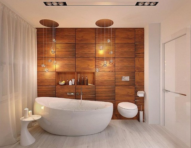 
Căn phòng tắm hiện đại và ấm cúng với chất liệu gỗ tự nhiên ốp tường cùng với những đường cong uyển chuyển của các thiết bị nhà tắm.
