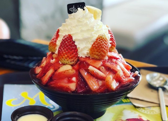 Bingsu: Đây là món ăn mùa hè bạn không thể bỏ qua bởi sự kết hợp độc đáo với vẻ ngoài siêu bắt mắt khiến bạn thòm thèm. Bingsu được chế biến từ đá bào mịn, kem béo ngậy, trộn trái cây tươi, bánh cookie, chocolate, trà xanh... Ảnh Instagram: Snptravelgram.