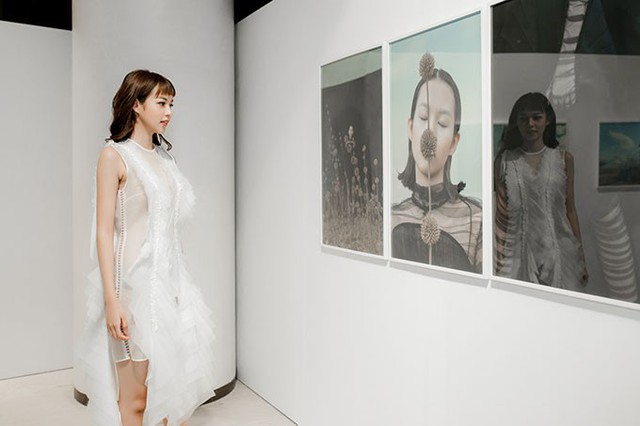 Nữ người mẫu ngắm tác phẩm nhiếp ảnh có tên The Stranger chụp chính cô được trưng bày tại triển lãm.