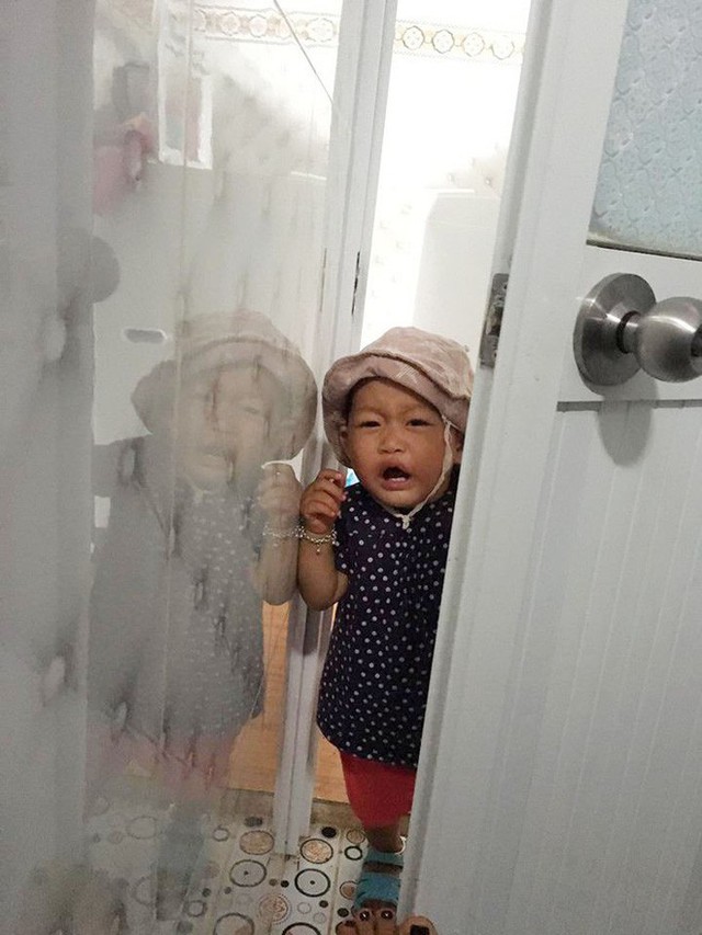 Cô bé khóc đòi mẹ bế theo vào nhà vệ sinh.