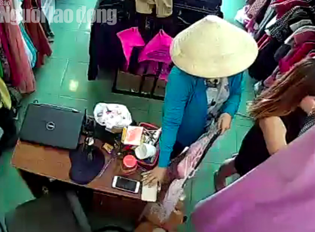 Người phụ nữ đội nón lá lợi dụng sơ hở của nhân viên đã trộm chiếc điện thoại của khách thử đồ. Ảnh cắt từ camera cửa hàng
