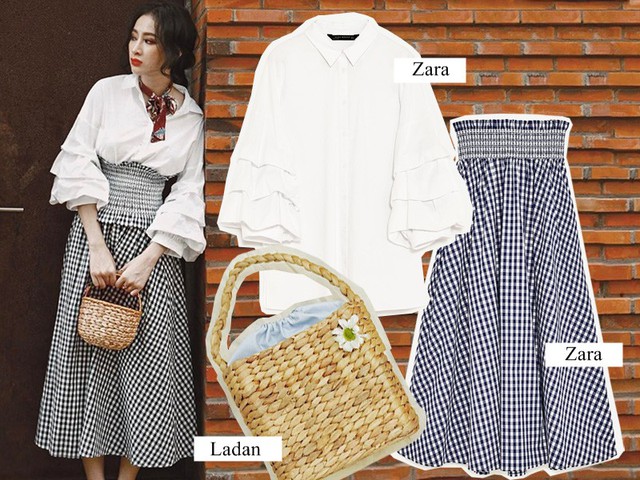 Với họa tiết kẻ gingham, cô chọn mẫu chân váy midi cạp cao, mix cùng sơ mi trắng, thêm chiếc khăn quàng bản mảnh và túi cói nhỏ mang dấu ấn hoài cổ, giúp kiều nữ nhấn nhá nét điệu đà. (Áo sơ mi: 999.000VND – Chân váy: 999.000VND)