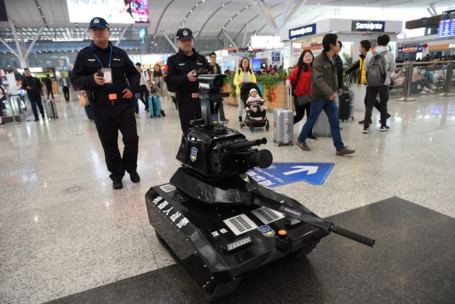 Cảnh sát Trung Quốc điều khiển robot tuần tra phía bên trong nhà ga Bắc Kinh. Ảnh: Reuters.