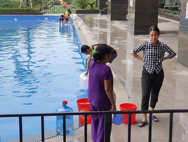Cư dân mang quần áo giặt giũ, múc nước bể bơi để dùng trong cơn khát ở Hà Nội - Ảnh 5.