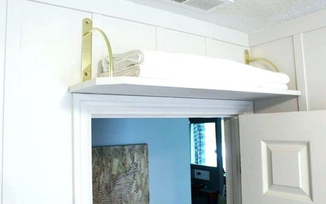 
9. Bạn có thể thêm nhiều không gian lưu trữ cho một nhà bếp nhỏ bằng cách lắp đặt một kệ phía trên cửa ra vào. Đúng vậy, không gian nhỏ trên đó mà mọi người vẫn thường bỏ qua thực sự hữu ích. Kệ phòng tắm đơn giản phía trên cửa này cho phép bạn lưu trữ thêm khăn hoặc giấy vệ sinh cuộn.
