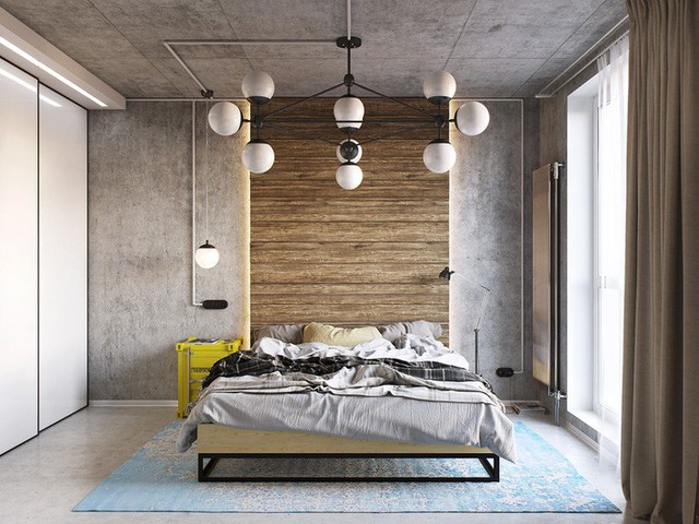 
Một tấm gỗ lớn kéo từ đầu giường cao mở rộng lên đến trần nhà. Nó là một cảm ứng đương đại tự nhiên trái ngược với những bức tường màu xám lạnh bao quanh, nhưng bề mặt gồ ghề của nó đã mô tả đúng tính chất của phong cách công nghiệp.
