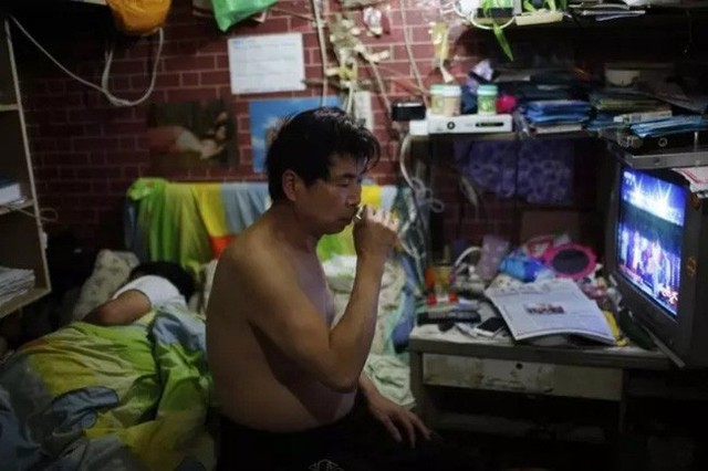 
Xiao Cao, nghệ sỹ đường phố, cùng vợ chung sống trong căn hộ rộng 8m2 phía sau một nhà vệ sinh công cộng ở Thượng Hải.
