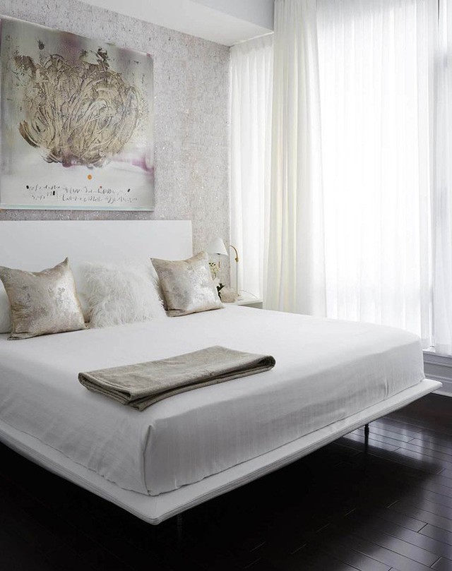 
Sàn nhà gỗ đậm màu càng làm không gian phòng ngủ với sắc trắng cơ bản thêm nổi bật.
