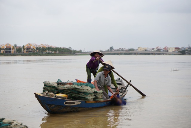 Người dân chèo thuyền cứu người phụ nữ tự tử bị dòng nước cuốn trôi - Ảnh 2.