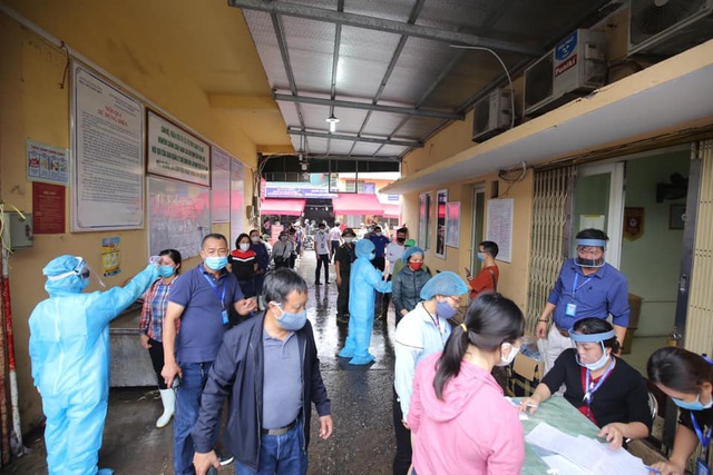 Cận cảnh kiểm soát thân nhiệt, tets nhanh COVID-19 người dân ra vào chợ đầu mối, chợ dân sinh tại Hà Nội  - Ảnh 4.