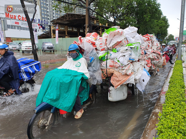 TP.HCM: S&aacute;ng nắng gắt, chiều mưa lớn kinh ho&agrave;ng khiến người d&acirc;n ướt sũng, b&igrave; b&otilde;m dắt xe lội nước - Ảnh 16.