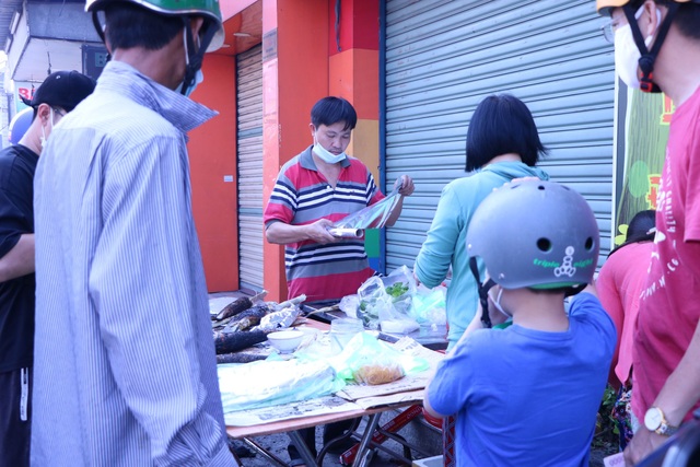 Người Sài Gòn đội nắng đi mua cá lóc nướng ngày vía Thần Tài - Ảnh 1.