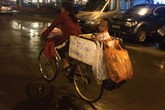 Bức ảnh xúc động người mẹ chở con đạp xe trong mưa gió Bức ảnh xúc động người mẹ chở con đạp xe trong mưa gió