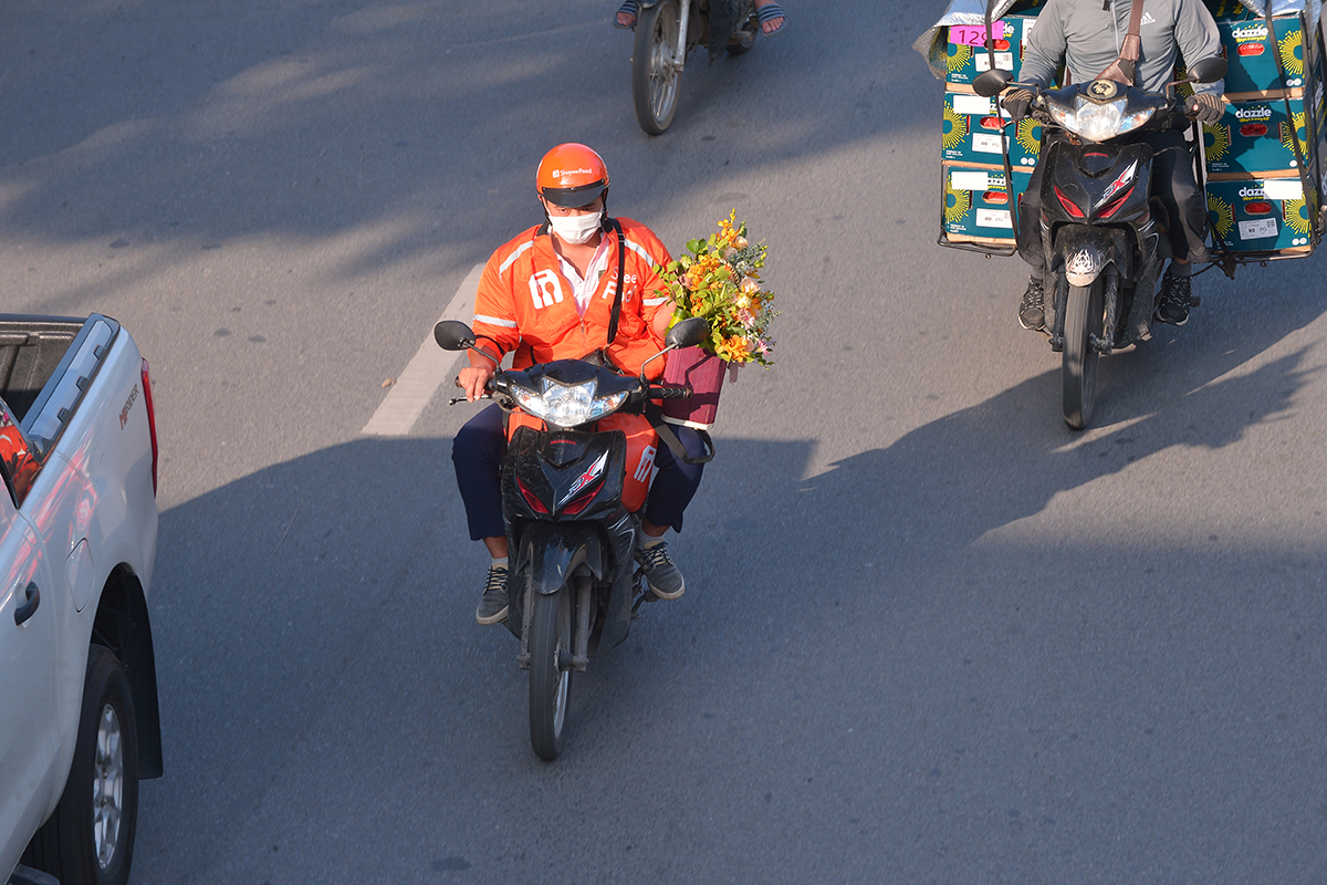 Shipper hoa tất bật khắp đường phố trong ngày Phụ nữ Việt Nam - Ảnh 7.
