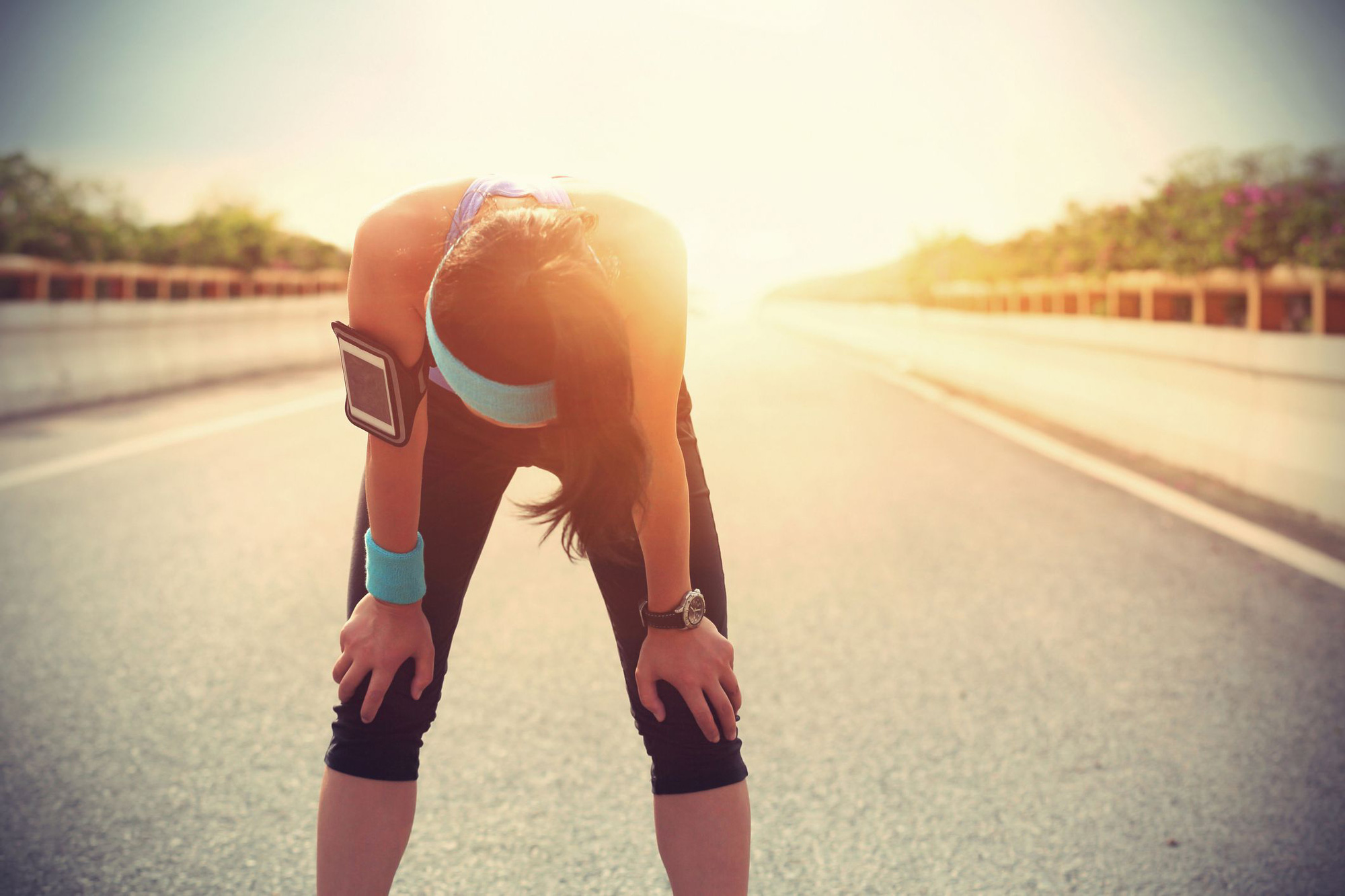 tired-woman-runner-taking-a-rest-after-running-hard-royalty-free-image-477815606-1566669912.jpeg
