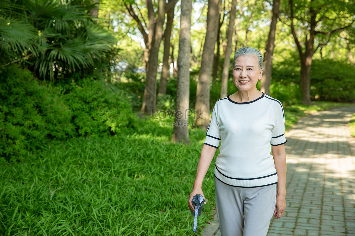 lovepik-elderly-woman-walking-outdoors-holding-a-drinking-picture_501618891