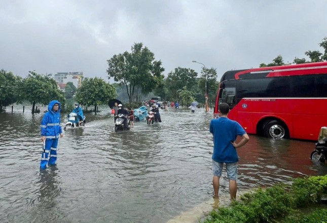 Hà Nội dùng xe công vụ chở người dân qua đường bị ngập - Ảnh 1.