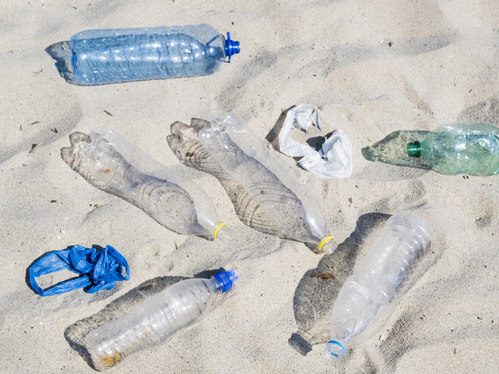 empty-plastic-water-bottles-plastic-bag-sand-26368280079139296135979-1739146355779-1739146356033435316907.jpg