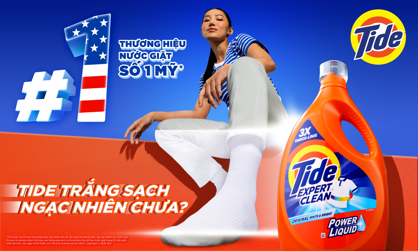 A person sitting on a wall with a bottle of laundry detergent  Description automatically generated