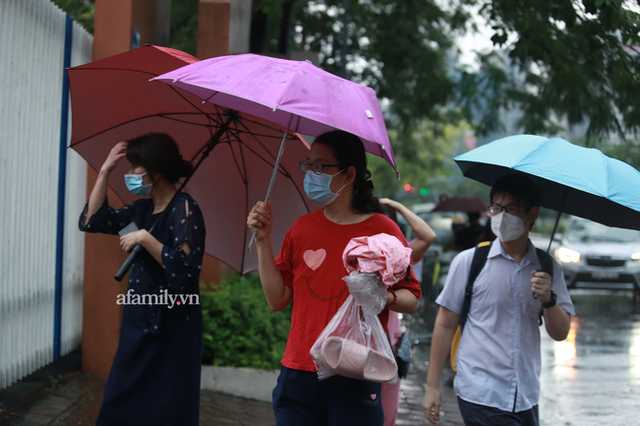 Mưa lớn như trút nước sáng 12/6, phụ huynh Hà Nội xách dép, đội mưa đưa con đi thi vào lớp 10 - Ảnh 8.