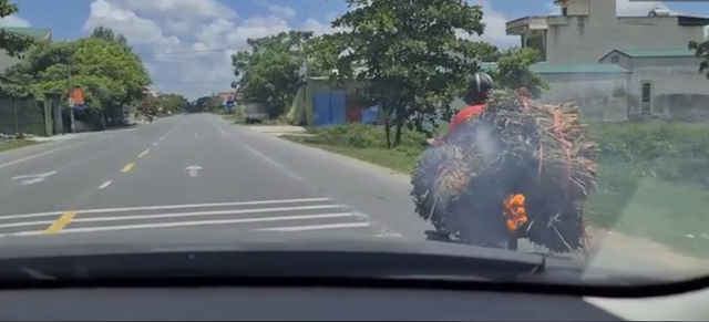 Đang chở hàng, người đàn ông đi xe máy không hề hay biết điều khủng khiếp đang xảy ra sau yên xe mình - Ảnh 1.