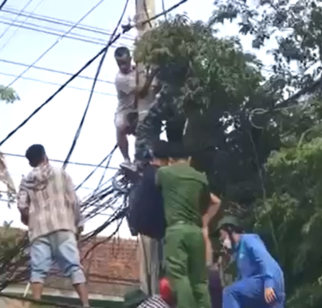 Nghẹt thở giải cứu người đàn ông bị điện cao thế phóng trúng, treo lơ lửng trên cột điện - Ảnh 1.