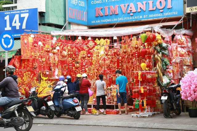 Hàng hóa Tết dồi dào, người dân rộn ràng mua sắm trước thềm năm mới - Ảnh 2.