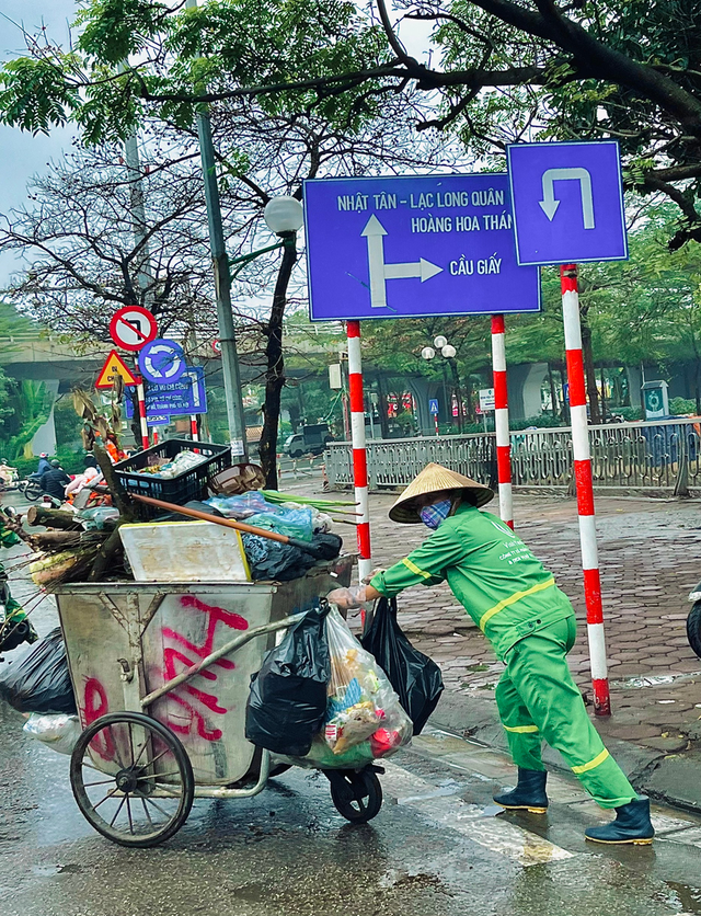 Những người lao công tận tâm trên khắp các con phố Hà Nội trong ngày mưa phùn giăng mắc - Ảnh 4.