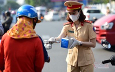 Nữ cảnh sát đội nắng phát khẩu trang ở cửa ngõ Tân Sơn Nhất