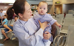 Con trai Khánh Ly ngơ ngác, được bà ngoại bế ở sân bay