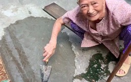 Xôn xao clip cụ bà ngoài 80 tuổi tự trộn xi-măng “vá” đường ở TP.HCM