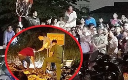 Chen chúc xem xác chó nằm trong hộp đá hoa cương ở bãi rác Sài Gòn