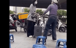 Người phụ nữ bán nước ở bến xe Mỹ Đình xua đuổi, đá hành lý của cô gái đợi xe trên vỉa hè